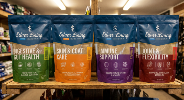 Silver Lining Herbs equine supplements lined on a barn shelf
